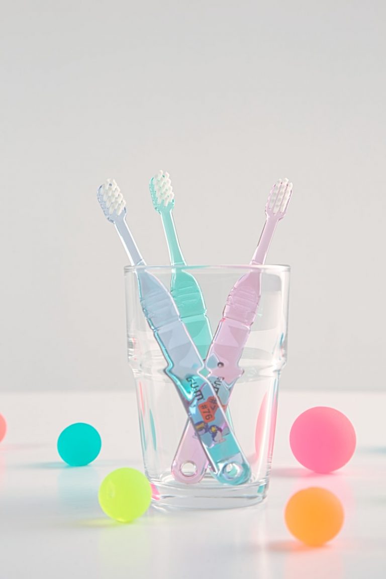 a group of toothbrushes in a glass cup